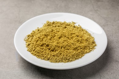 Photo of Henna powder on grey background. Natural hair coloring