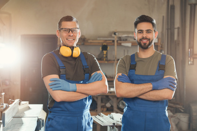 Portrait of professional male carpenters in workshop