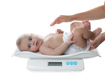 Young woman weighting cute baby on white background. Health care