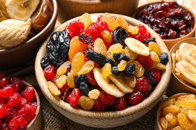 Bowls with different dried fruits on table, closeup. Healthy lifestyle