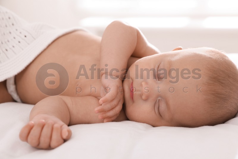 Cute little baby sleeping in bed at home, closeup
