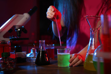 Child doing chemical research in laboratory, closeup. Dangerous experiment
