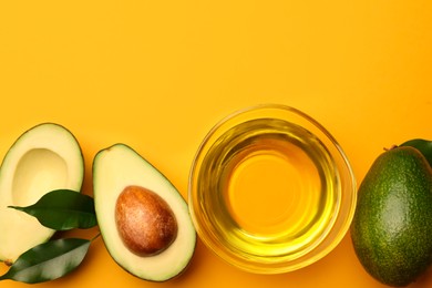Photo of Cooking oil in bowl and fresh avocados on yellow background, flat lay. Space for text