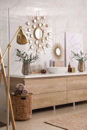 Photo of Modern bathroom interior with stylish mirror, floor lamp and vessel sink