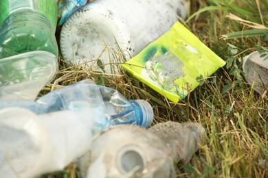 Garbage scattered on grass, closeup. Environment pollution problem