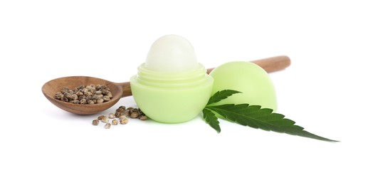 Hemp lip balm, green leaf and spoon with seeds on white background. Natural cosmetics