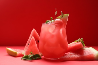 Tasty watermelon drink and fresh fruits on red background