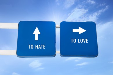 Road signs with different directions - TO HATE or TO LOVE outdoors