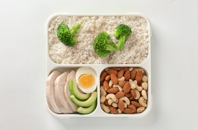Container with natural healthy lunch on white background, top view. High protein food