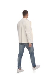Photo of Man in casual outfit walking on white background, back view