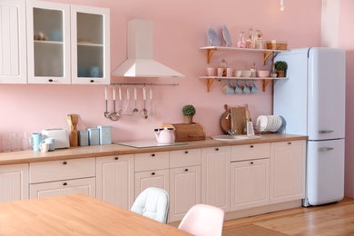Stylish kitchen interior with counter and fridge
