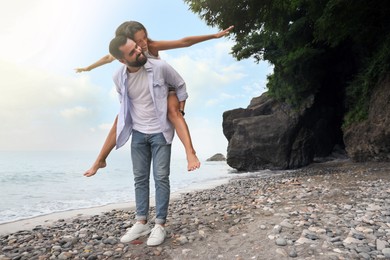 Happy young couple having fun on beach sea. Space for text