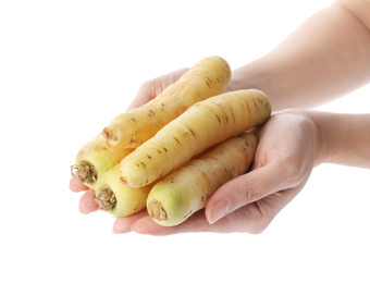 Woman holding raw carrots on white background, closeup