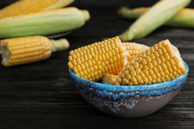 Bowl with tasty sweet corn cobs on table, closeup