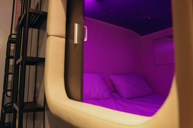Capsule with twin bed in modern pod hostel. Stylish interior