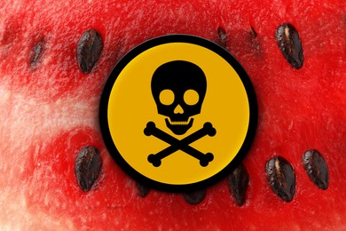 Skull and crossbones sign on ripe watermelon, closeup. Be careful - toxic