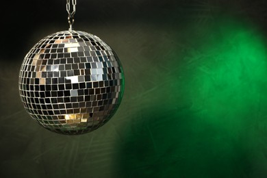 Shiny disco ball on dark background. Space for text