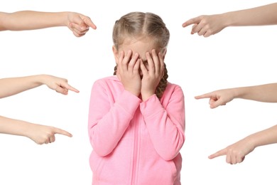 Photo of Kids pointing at upset girl on white background. Children's bullying