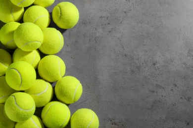 Tennis balls on grey table, flat lay. Space for text