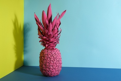 Photo of Pink pineapple on color background, space for text. Creative concept