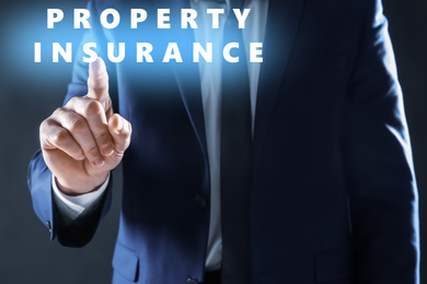 Property insurance concept. Man using virtual screen, closeup