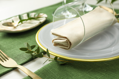 Photo of Stylish tableware with leaves on table. Festive setting