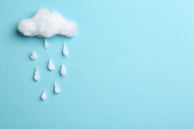 Cloud and raindrops made of cotton on blue background, flat lay. Space for text