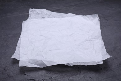 Photo of Sheets of baking paper on black table