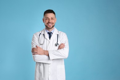 Pediatrician with stethoscope on light blue background. Space for text