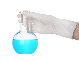 Scientist in gloves holding laboratory flask with light blue liquid on white background, closeup
