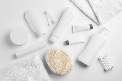 Composition with baby cosmetic products on white background, top view
