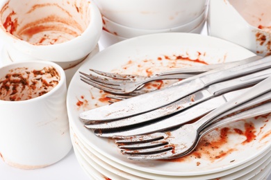 Pile of dirty dishes and cutlery, closeup