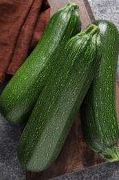 Raw ripe zucchinis on grey table, top view