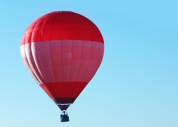 Beautiful view of hot air balloon in blue sky. Space for text