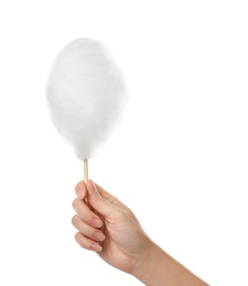 Woman holding stick with yummy cotton candy on white background, closeup