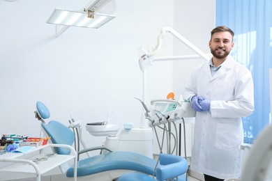 Portrait of professional dentist at workplace in clinic