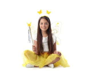 Cute little girl in fairy costume with yellow wings and magic wand on white background