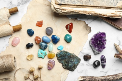 Flat lay composition with different gemstones on white marble background