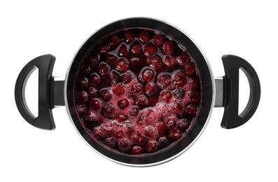 Pot with cherries in sugar syrup on white background, top view. Making delicious jam