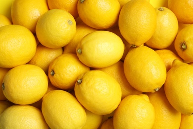 Many fresh ripe lemons as background, top view