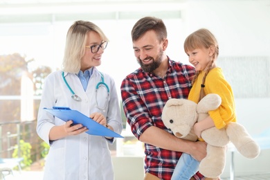 Little girl with father visiting children's doctor in hospital