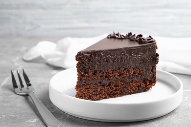 Delicious fresh chocolate cake served on grey table, closeup