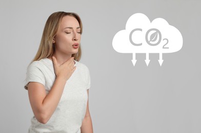 Reduce CO2 emissions. Young woman suffering from pain during breathing on light grey background