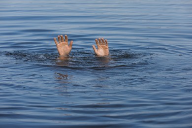 Drowning man reaching for help in sea, closeup