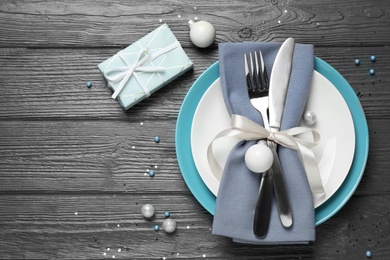 Photo of Beautiful Christmas table setting on grey wooden background, flat lay