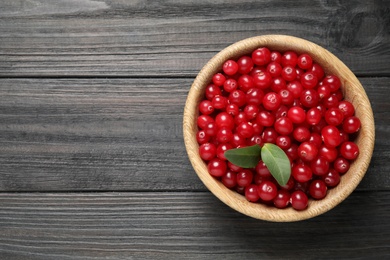 Ripe fresh cranberry on grey wooden table, top view. Space for text