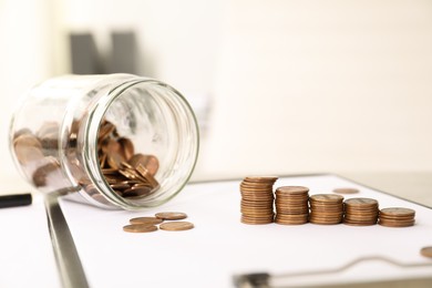 Stacks of coins on table against blurred background