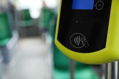 Photo of Contactless fare payment device in public transport, closeup. Space for text