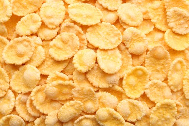 Sweet tasty corn flakes as background, top view