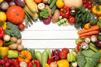 Photo of Frame of different fresh vegetables on white wooden table, flat lay. Space for text